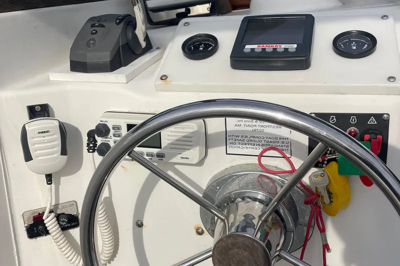 Slide: The Image of 1993 Tripp Angler 22 boat dashboard with steering wheel and navigation equipment. - 4