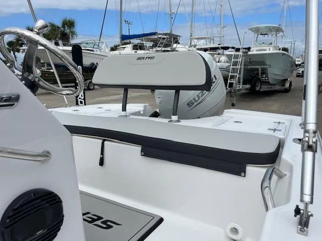 Slide: The Image of 2025 Sea Pro 172 Bay boat interior with Suzuki engine, docked at marina. - 6
