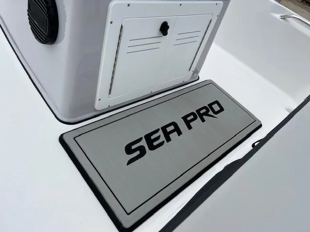 Slide: The Image of 2025 Sea Pro 172 Bay boat deck with logo and storage compartment. - 8