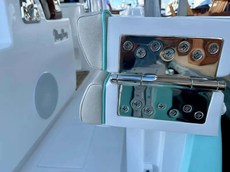 Slide: The Image of 2025 Mag Bay 38 CC boat hinge detail with polished metal and cushioned support. - 30