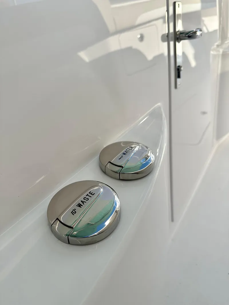 Slide: The Image of 2025 Mag Bay 38 CC boat waste disposal caps on sleek white surface. - 32