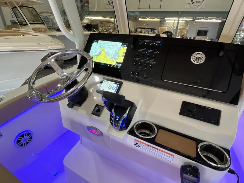 Slide: The Image of 2025 Scout 240 XSF boat dashboard with navigation system and controls. - 16