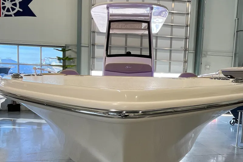 Slide: The Image of 2025 Scout 240 XSF boat in showroom, front view. - 2