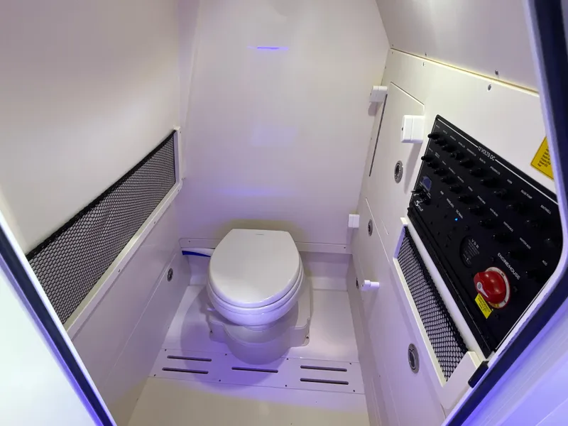 Slide: The Image of 2025 Scout 240 XSF boat interior with toilet and control panel. - 25