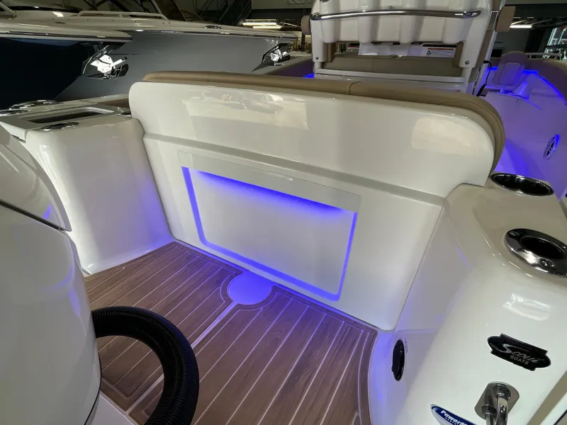 Slide: The Image of 2025 Scout 240 XSF boat interior with blue LED lighting and sleek design. - 9