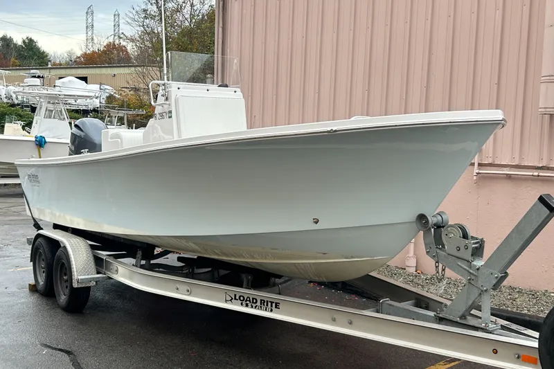 Slide: The Image of 2023 Jones Brothers 23 Cape Fisherman boat on trailer, parked outdoors. - 11