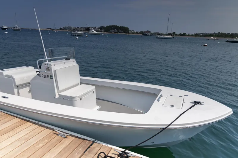 Slide: The Image of 2023 Jones Brothers 23 Cape Fisherman boat docked on calm water. - 12