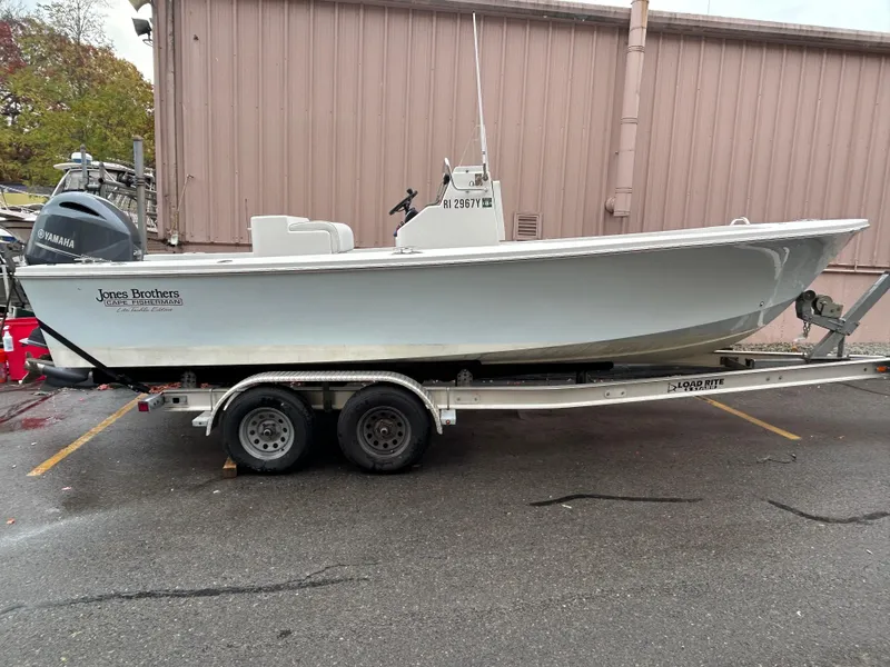 Slide: The Image of 2023 Jones Brothers 23 Cape Fisherman boat on trailer, parked outdoors. - 13