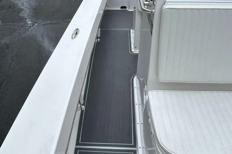 Slide: The Image of 2023 Jones Brothers 23 Cape Fisherman boat interior with white seating and dark flooring. - 17