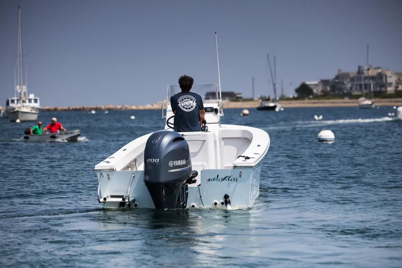 Slide: The Image of 2023 Jones Brothers 23 Cape Fisherman boat with Yamaha engine on calm water. - 2