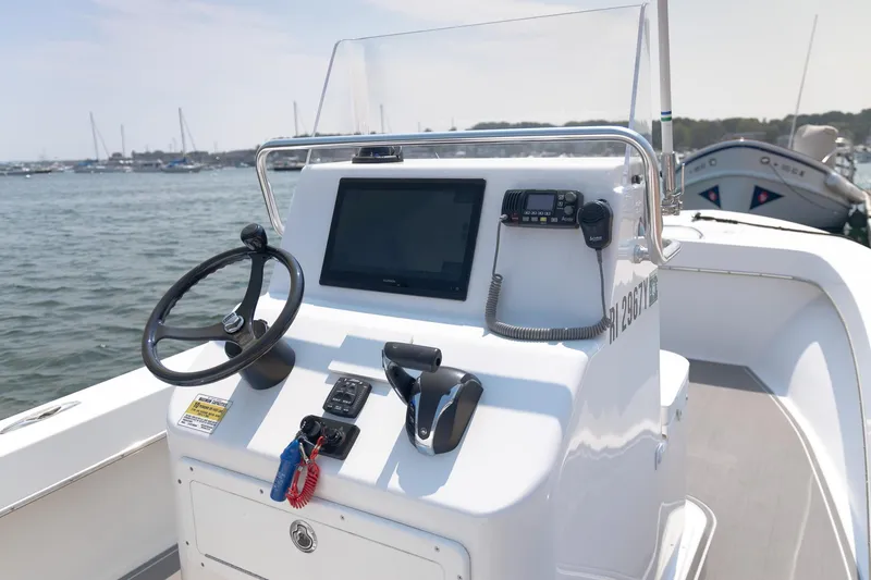 Slide: The Image of 2023 Jones Brothers 23 Cape Fisherman boat console with steering wheel and navigation equipment. - 25