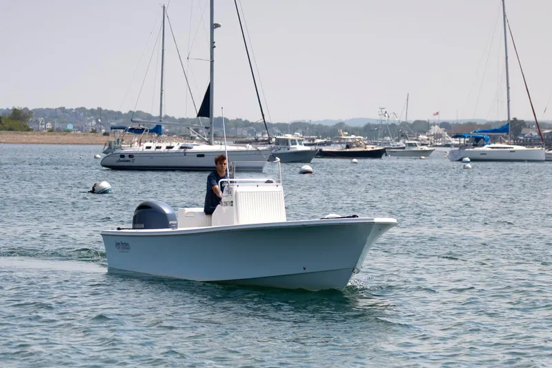 Slide: The Image of 2023 Jones Brothers 23 Cape Fisherman boat cruising in a busy harbor. - 3