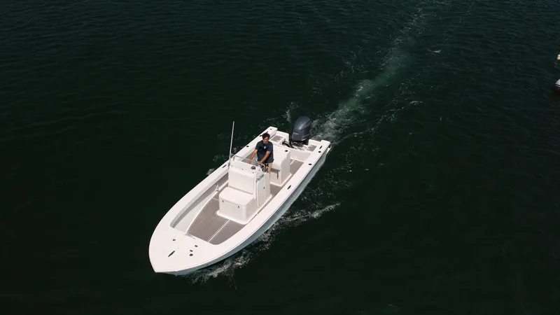 Slide: The Image of 2023 Jones Brothers 23 Cape Fisherman boat cruising on open water. - 31