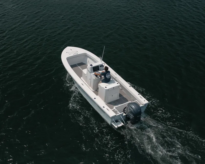 Slide: The Image of 2023 Jones Brothers 23 Cape Fisherman boat cruising on open water. - 32