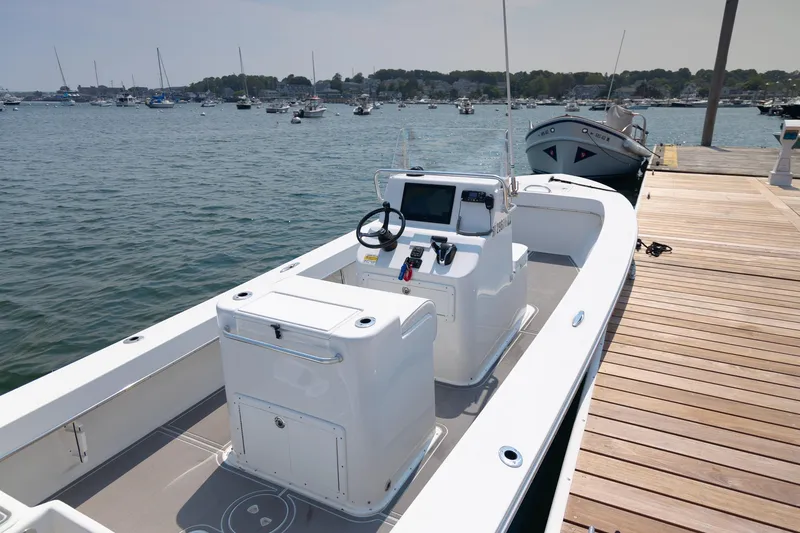 Slide: The Image of 2023 Jones Brothers 23 Cape Fisherman boat docked at a marina. - 5