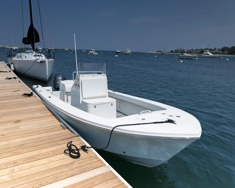 Slide: The Image of 2023 Jones Brothers 23 Cape Fisherman boat docked by wooden pier. - 6
