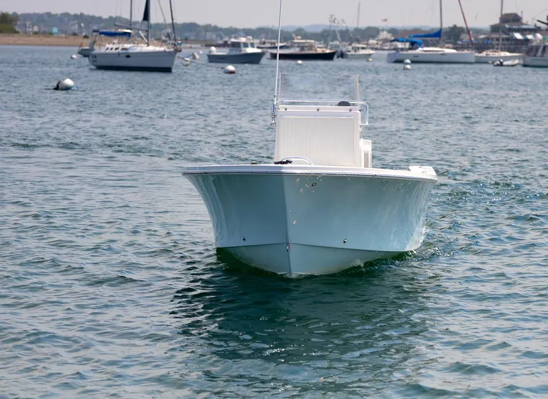 Slide: The Image of 2023 Jones Brothers 23 Cape Fisherman boat on calm water with other boats in background. - 8