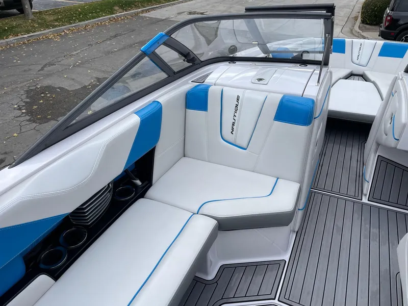 Slide: The Image of 2015 Nautique Super Air Nautique G25 interior with blue and white seating. - 10