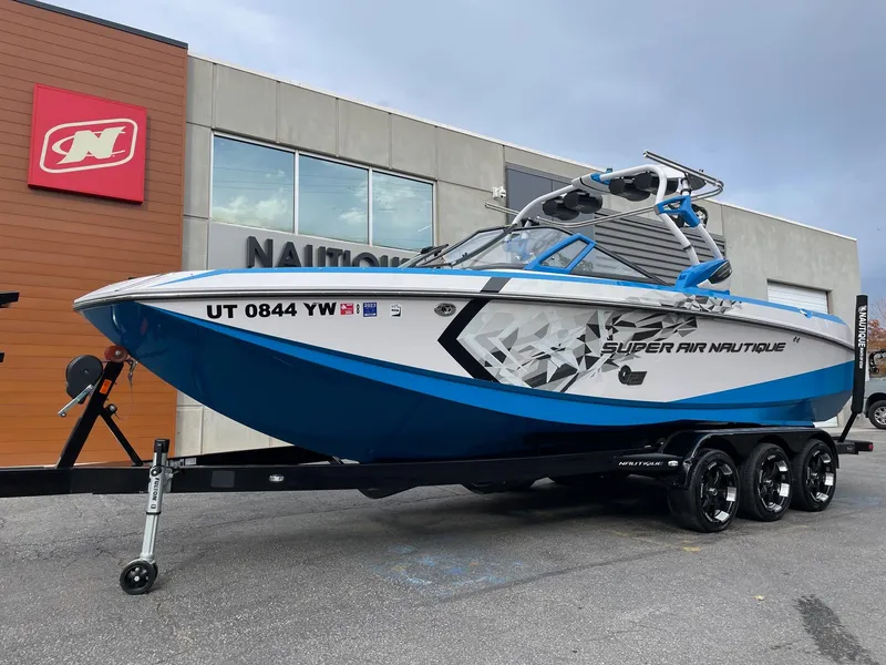 Slide: The Image of 2015 Nautique Super Air Nautique G25 boat on trailer, parked outside dealership. - 2
