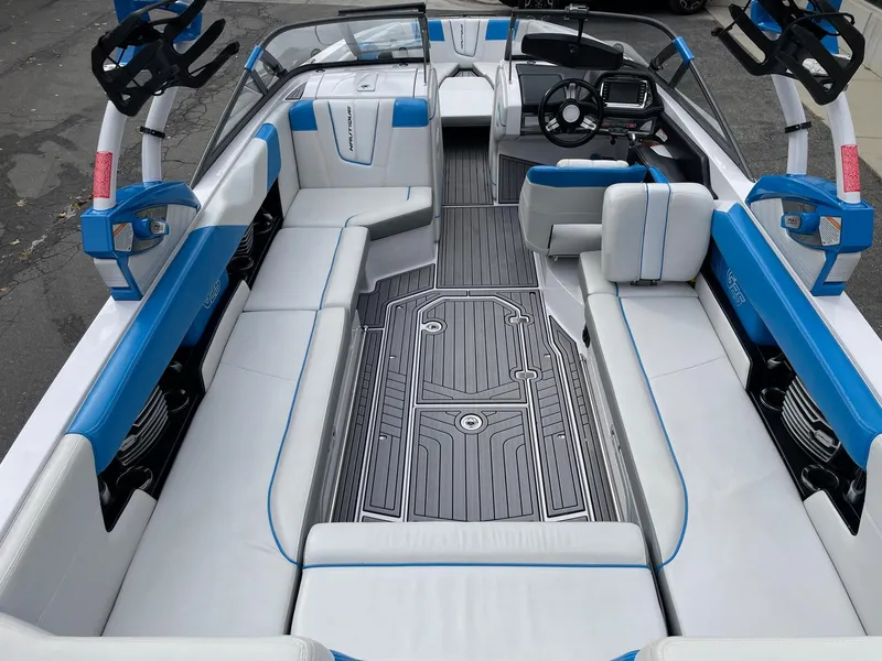 Slide: The Image of 2015 Nautique Super Air Nautique G25 interior with blue and white seating, sleek design. - 5