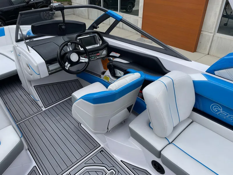 Slide: The Image of 2015 Nautique Super Air Nautique G25 boat interior with modern dashboard and seating. - 6