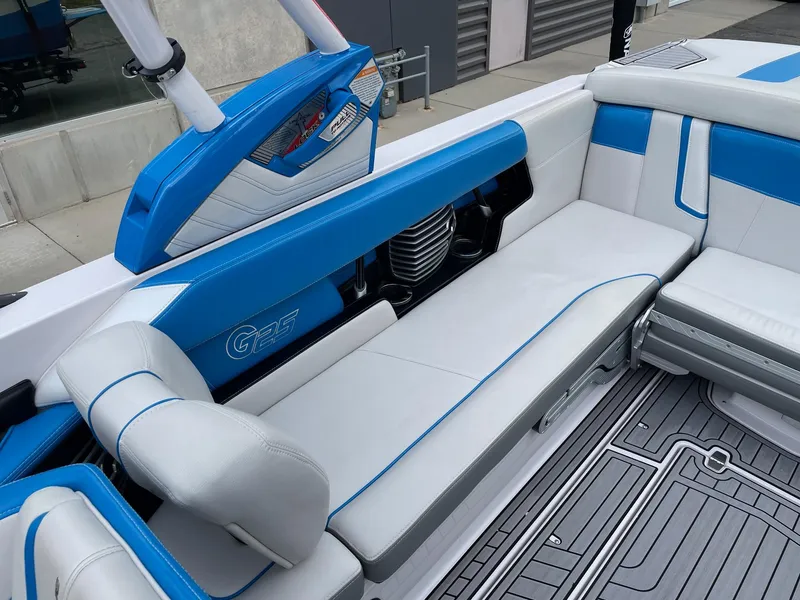 Slide: The Image of 2015 Nautique Super Air Nautique G25 interior with blue and white seating. - 7