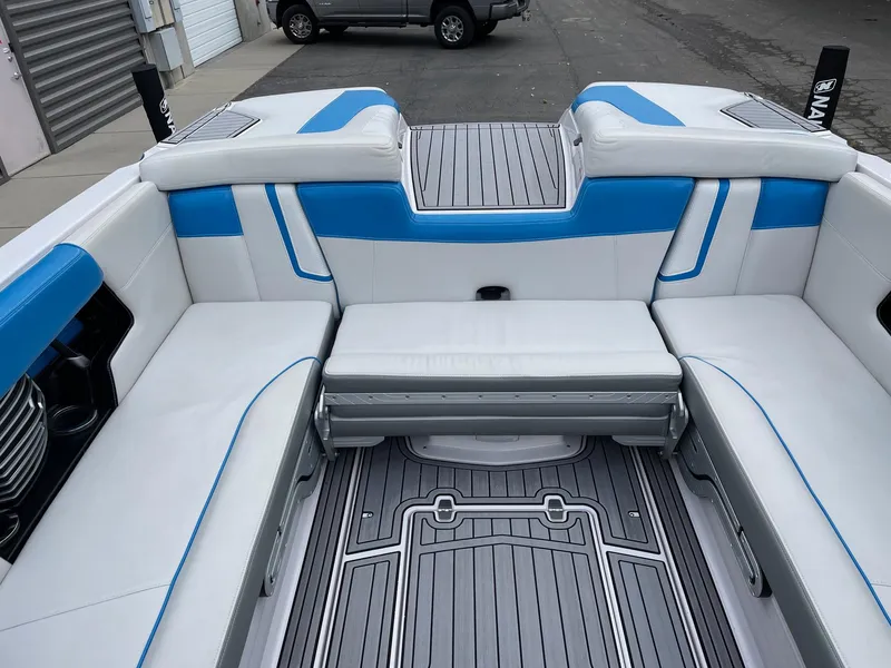 Slide: The Image of 2015 Nautique Super Air Nautique G25 interior with blue and white seating. - 8