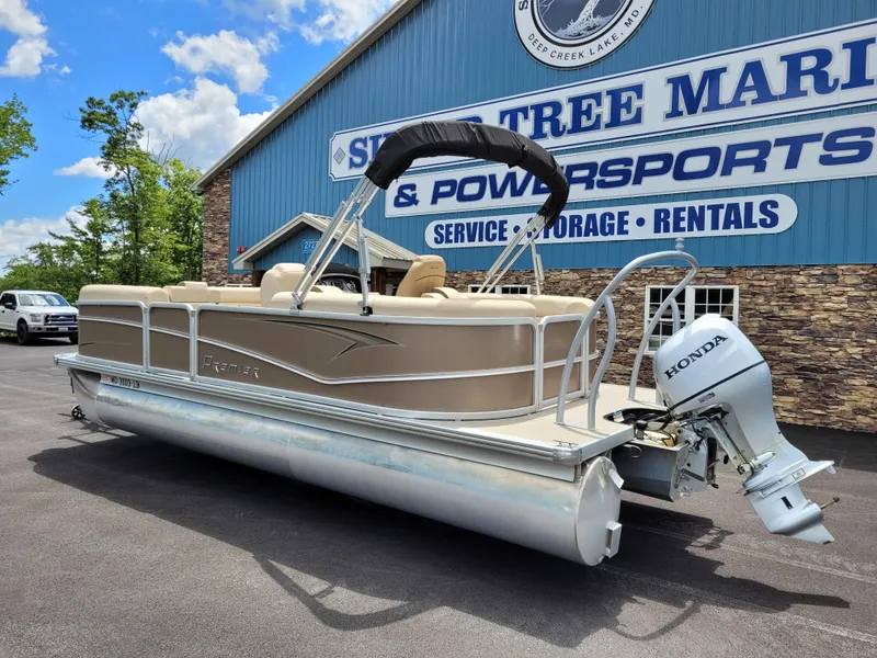 Slide: The Image of 2022 Premier 220 Sunspree RF pontoon boat with Honda motor at marina. - 2