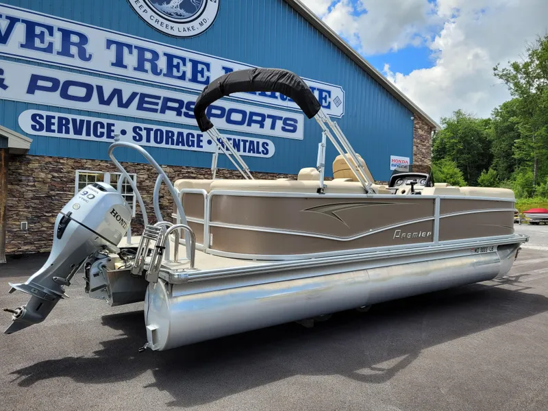 Slide: The Image of 2022 Premier 220 Sunspree RF pontoon boat with Honda outboard motor, parked outside dealership. - 5