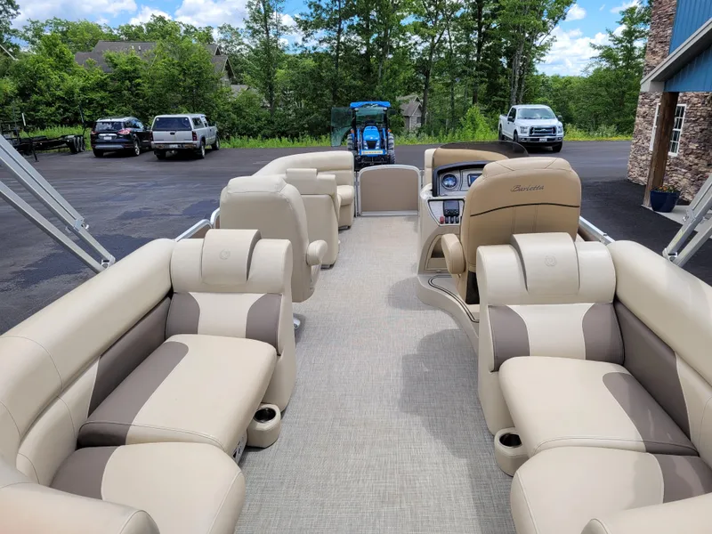 Slide: The Image of 2022 Premier 220 Sunspree RF pontoon boat with beige seating, parked outdoors. - 9