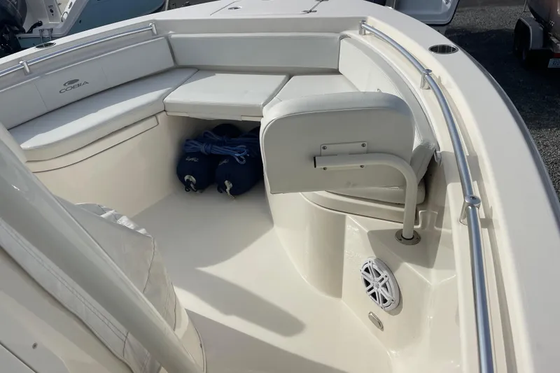 Slide: The Image of 2022 Cobia 220 Center Console boat interior with seating and storage. - 10