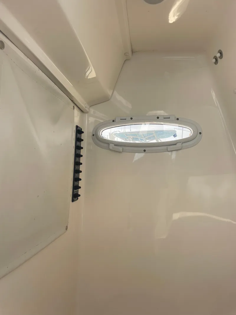Slide: The Image of Interior of 2022 Cobia 220 Center Console boat with oval window. - 12