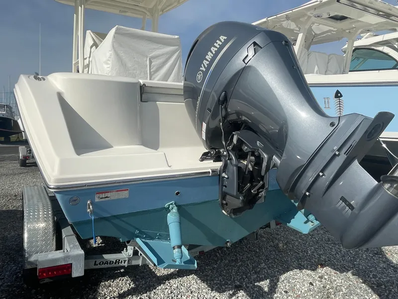 Slide: The Image of 2022 Cobia 220 Center Console boat with Yamaha outboard motor on trailer. - 2