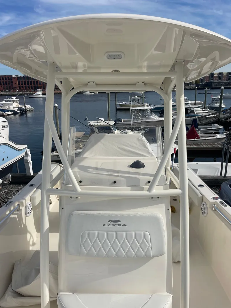 Slide: The Image of 2022 Cobia 220 Center Console boat docked at marina. - 9