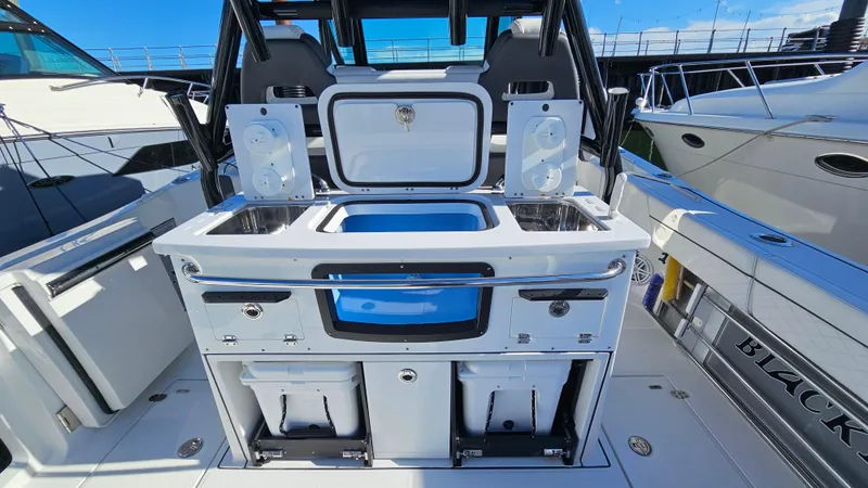 Slide: The Image of 2021 Blackfin 332 CC boat with a sleek fishing station and storage compartments. - 13