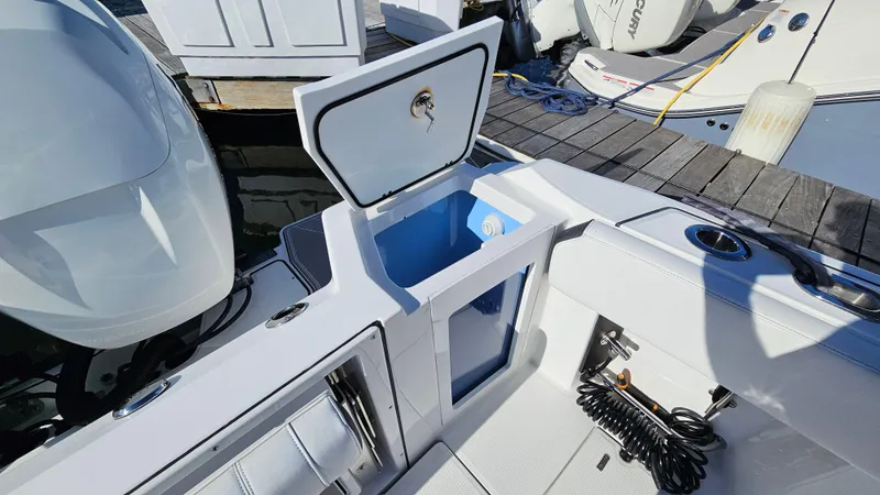 Slide: The Image of 2021 Blackfin 332 CC boat with open storage compartment at dock. - 19