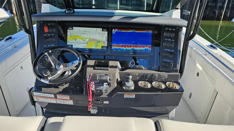 Slide: The Image of 2021 Blackfin 332 CC boat dashboard with navigation screens and controls. - 20