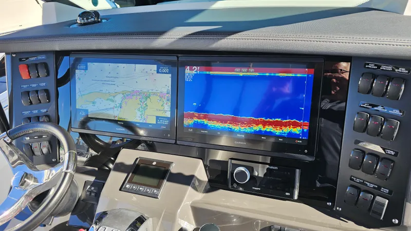 Slide: The Image of 2021 Blackfin 332 CC dashboard with navigation and sonar displays. - 21
