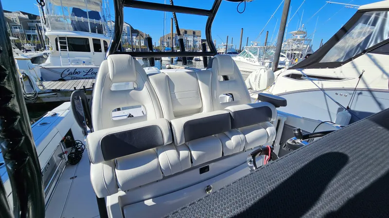 Slide: The Image of 2021 Blackfin 332 CC boat interior with luxurious seating at marina. - 28