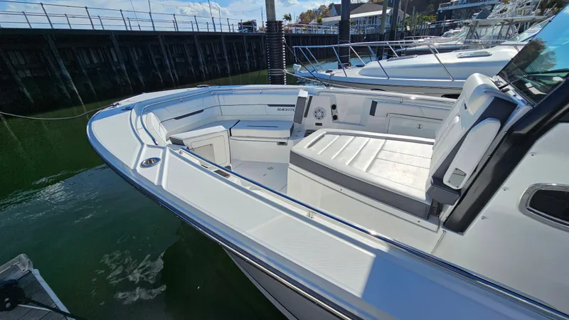 Slide: The Image of 2021 Blackfin 332 CC boat with spacious seating, docked in marina. - 37