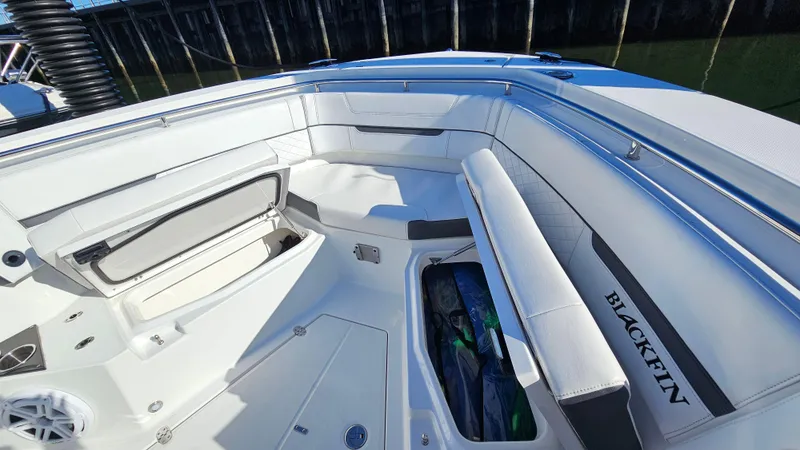 Slide: The Image of 2021 Blackfin 332 CC boat interior with spacious seating and storage compartments. - 42