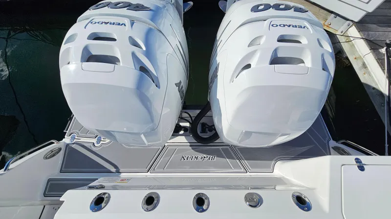 Slide: The Image of 2021 Blackfin 332 CC boat with twin outboard engines docked at marina. - 48