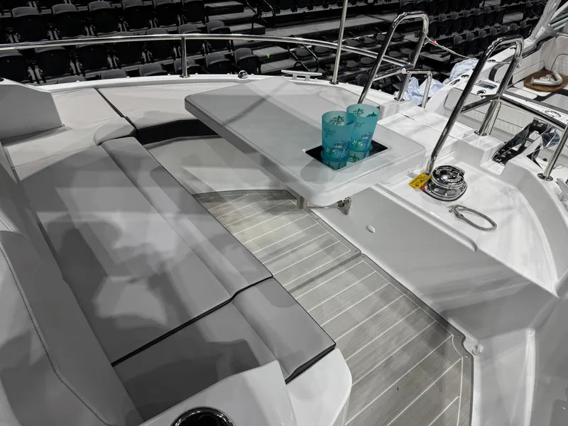 Slide: The Image of 2025 Jeanneau NC 895 Sport Series 2 boat interior with seating and table. - 26