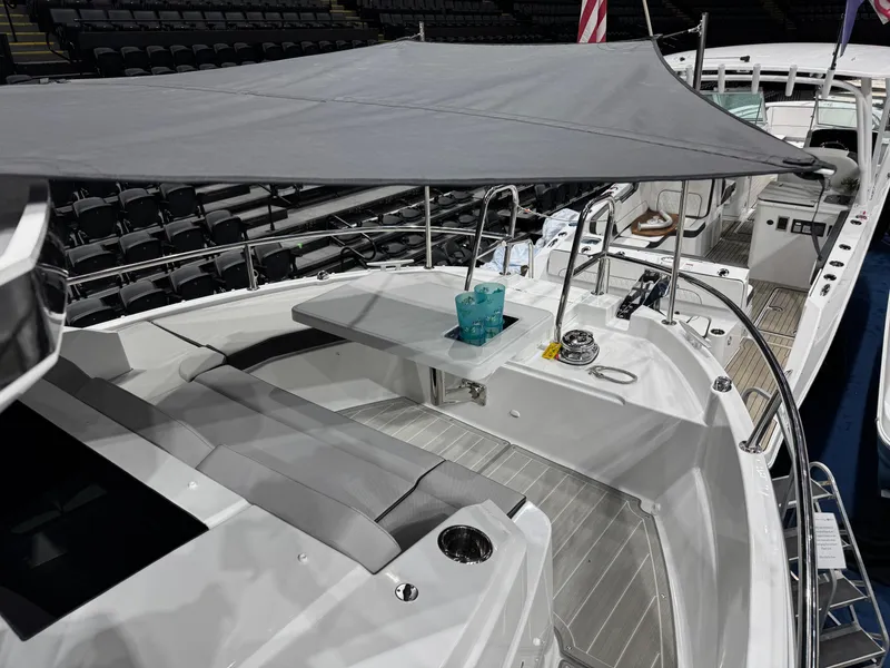 Slide: The Image of 2025 Jeanneau NC 895 Sport Series 2 boat with shaded seating area and modern design. - 27