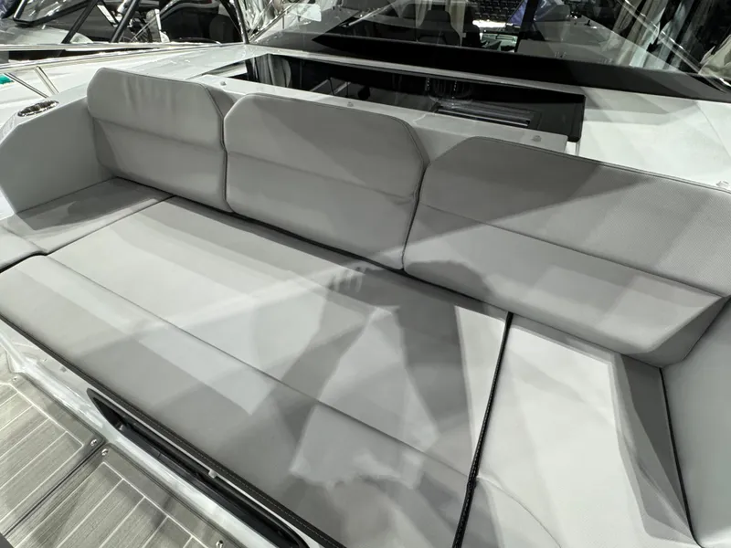 Slide: The Image of 2025 Jeanneau NC 895 Sport Series 2 boat seating area, featuring sleek gray upholstery. - 28