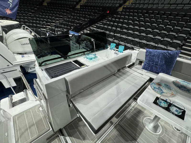 Slide: The Image of 2025 Jeanneau NC 895 Sport Series 2 interior with seating and table setup. - 4