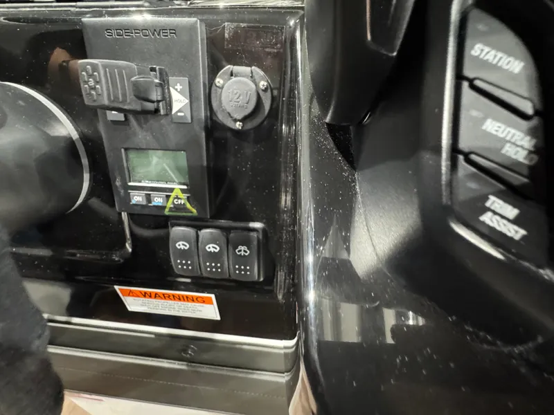 Slide: The Image of Control panel of 2025 Jeanneau NC 895 Sport Series 2 boat, featuring various switches and indicators. - 11
