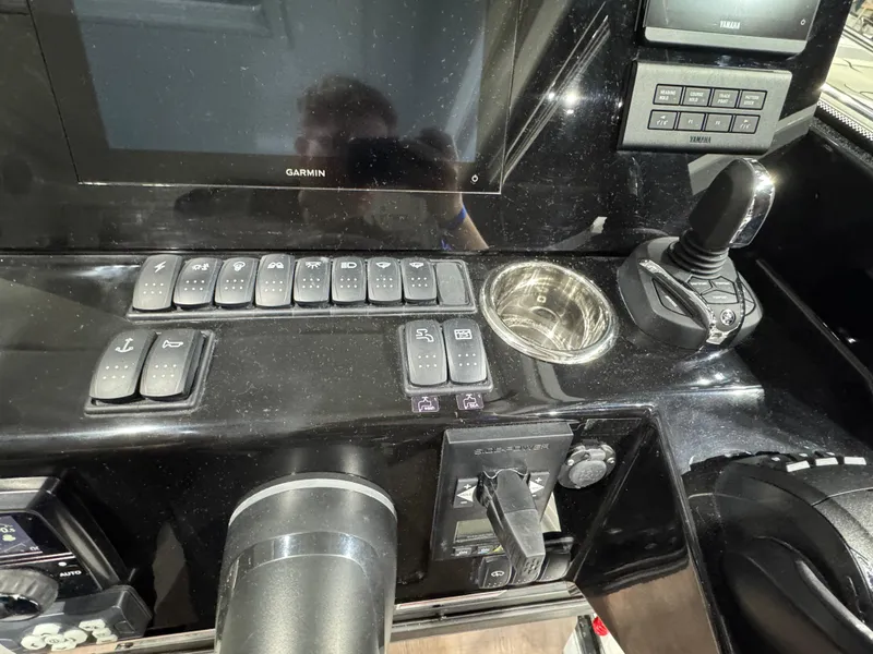 Slide: The Image of Control panel of 2025 Jeanneau NC 895 Sport Series 2 boat with joystick and switches. - 12