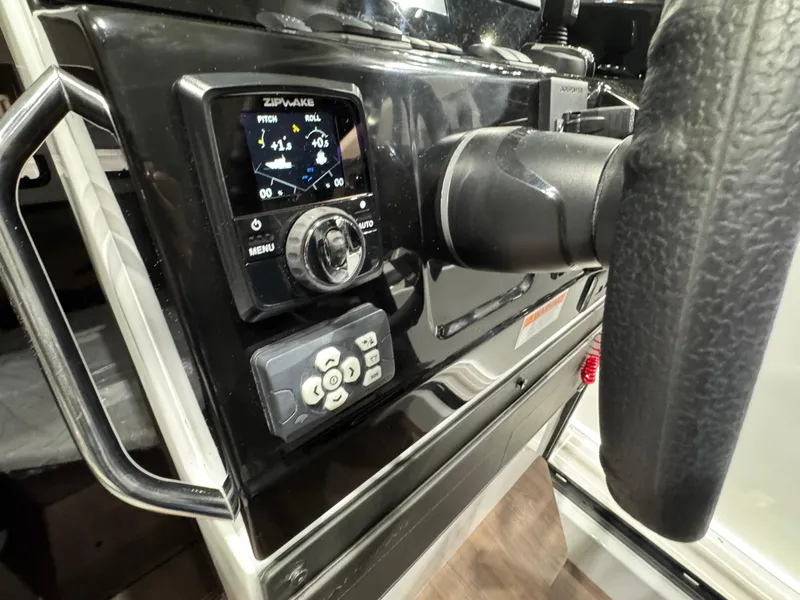 Slide: The Image of 2025 Jeanneau NC 895 Sport Series 2 dashboard with steering wheel and control panel. - 13