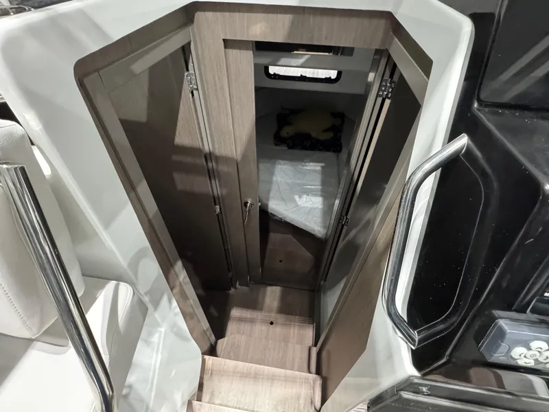 Slide: The Image of 2025 Jeanneau NC 895 Sport Series 2 cabin interior with wooden stairs and compact design. - 15